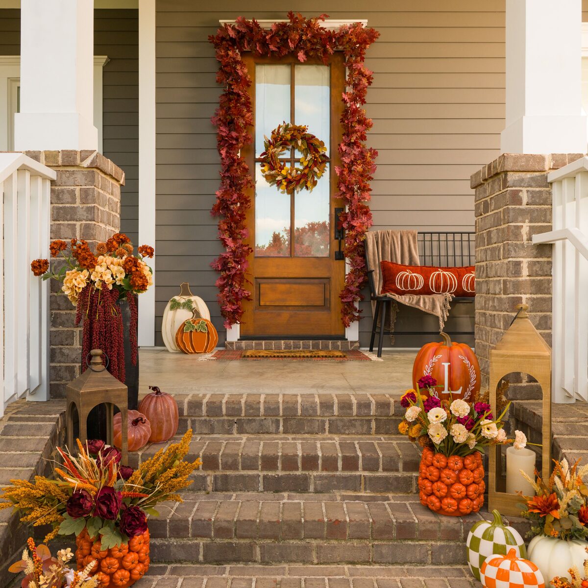 Cozy fall patio with pumpkins and warm textiles