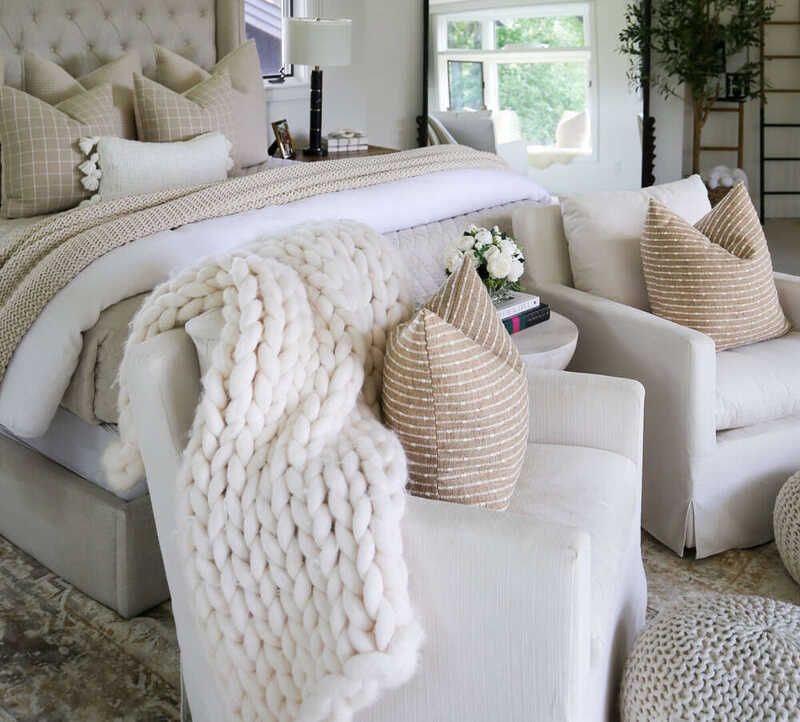 Layered neutral bedding creating luxury hotel look